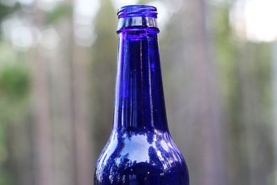 Close-up of glass bottle against blurred background