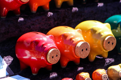 Close-up of colorful piggy banks in a row in store