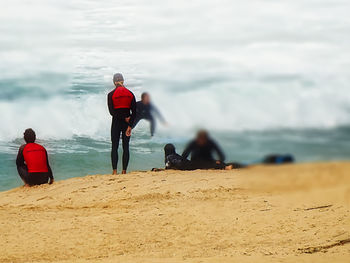 Rear view of people on beach