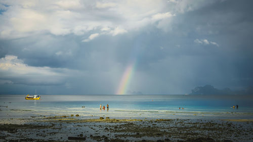 Scenic view of beach against dramatic sky