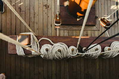 High angle view of ropes tied on boat deck