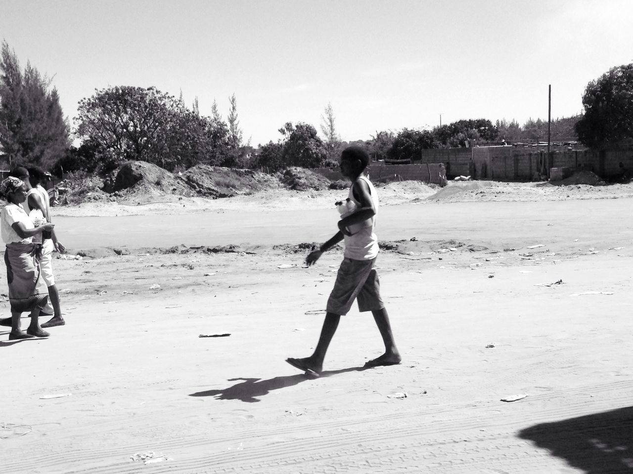 full length, lifestyles, leisure activity, person, casual clothing, childhood, enjoyment, beach, fun, young adult, elementary age, sand, happiness, boys, standing, front view, sunlight, girls