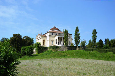 Low angle view of house on field against sky