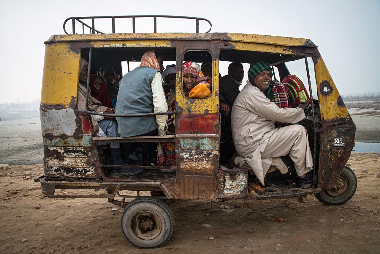 transportation, mode of transport, real people, land vehicle, men, pick-up truck, day, sitting, women, outdoors, car, off-road vehicle, working, occupation, sky, adult, people