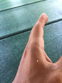 Close-up of person hand on swimming pool