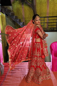 Midsection of woman standing by red umbrella