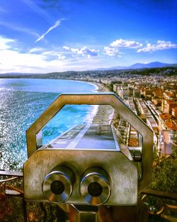 Metallic structure by sea against sky