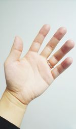 Close-up of human hand against white background