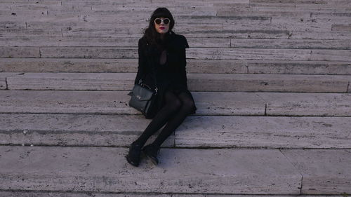 Portrait of young woman on steps