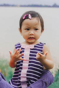 Portrait of cute boy holding purple outdoors