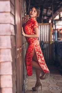 Portrait of young woman with red umbrella