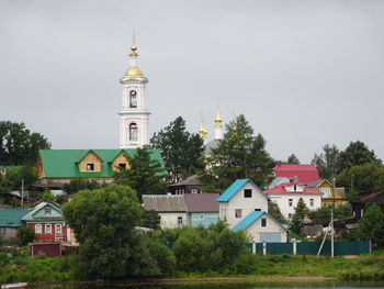 View of trees and buildings against sky