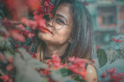 Close-up of young woman with flowers