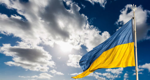 Low angle view of flag against sky