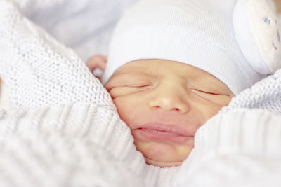 Close-up of baby sleeping on bed