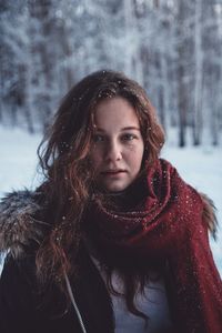 Portrait of young woman in snow covered forest