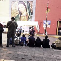 Man and woman playing guitar in city