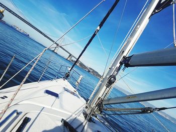 Sailboat sailing in sea against blue sky