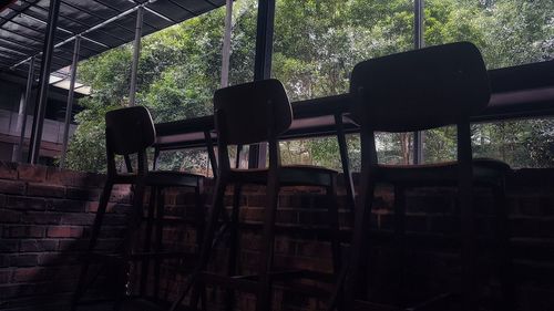 Low angle view of empty chairs in window