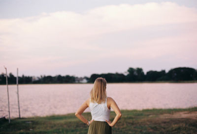 Rear view of woman standing against sky