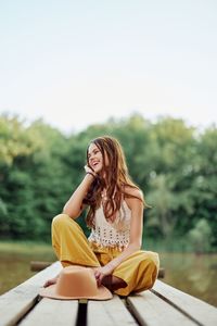 Young woman sitting on bench