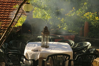 Empty chairs and tables in water