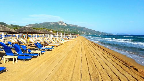 Panoramic view of beach against clear blue sky