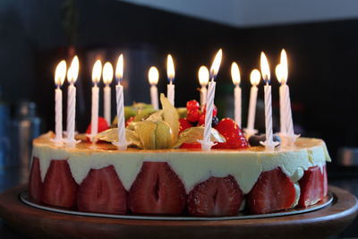 Close-up of lit candles on birthday cake
