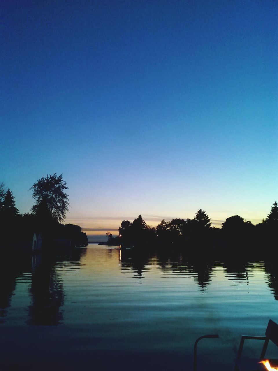 water, silhouette, clear sky, copy space, sunset, tranquil scene, tranquility, scenics, sea, beauty in nature, blue, reflection, tree, nature, palm tree, horizon over water, dusk, sky, idyllic, lake