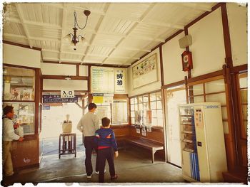 Rear view of people walking in corridor