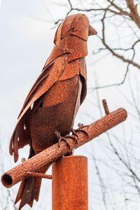 Close-up of rusty pole against sky