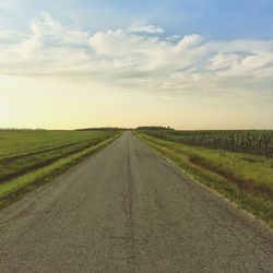 Country road passing through field