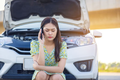 Portrait of a young woman in car