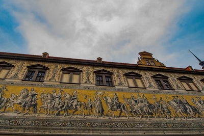 Low angle view of building against cloudy sky