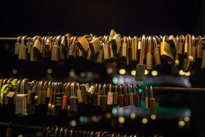 Close-up of padlocks hanging on railings