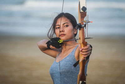 Young woman standing against the sea