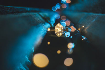 Close-up of man holding illuminated light