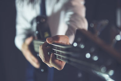 Close-up of man playing guitar