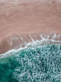 High angle view of sea and sand