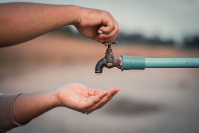 Close-up of hands holding metal