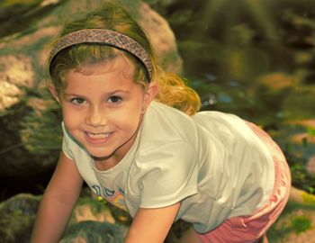 Portrait of little girl rock climbing fossil finding 