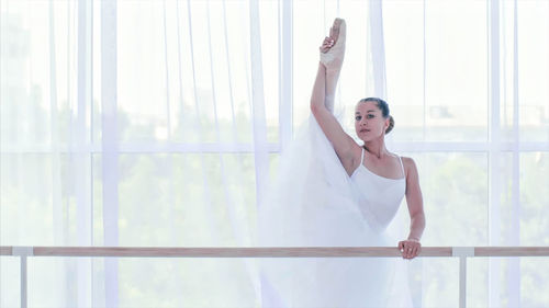 Portrait of ballerina dancing in dance studio