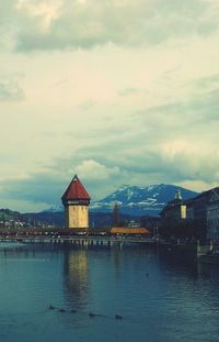 Built structure in water against cloudy sky