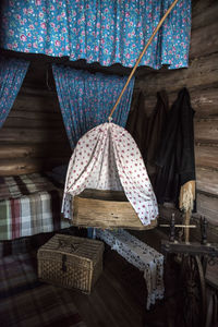 Close-up of wicker basket hanging on wood