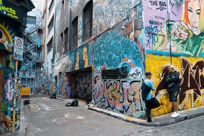 Graffiti on wall by street in city