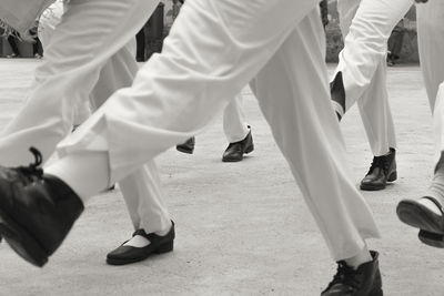 Low section of people marching on footpath