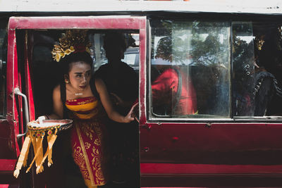 Woman standing by window