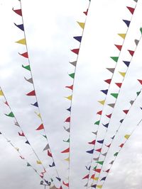 Low angle view of bunting hanging against sky
