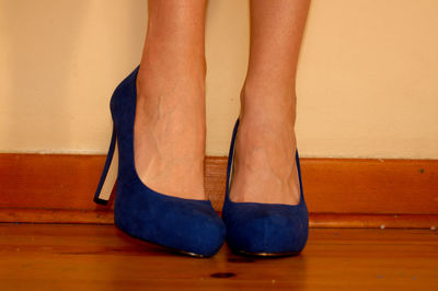 Low section of woman standing on hardwood floor