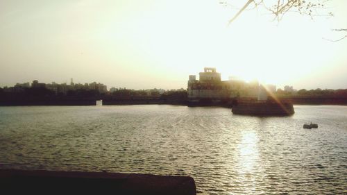 Scenic view of river at sunset